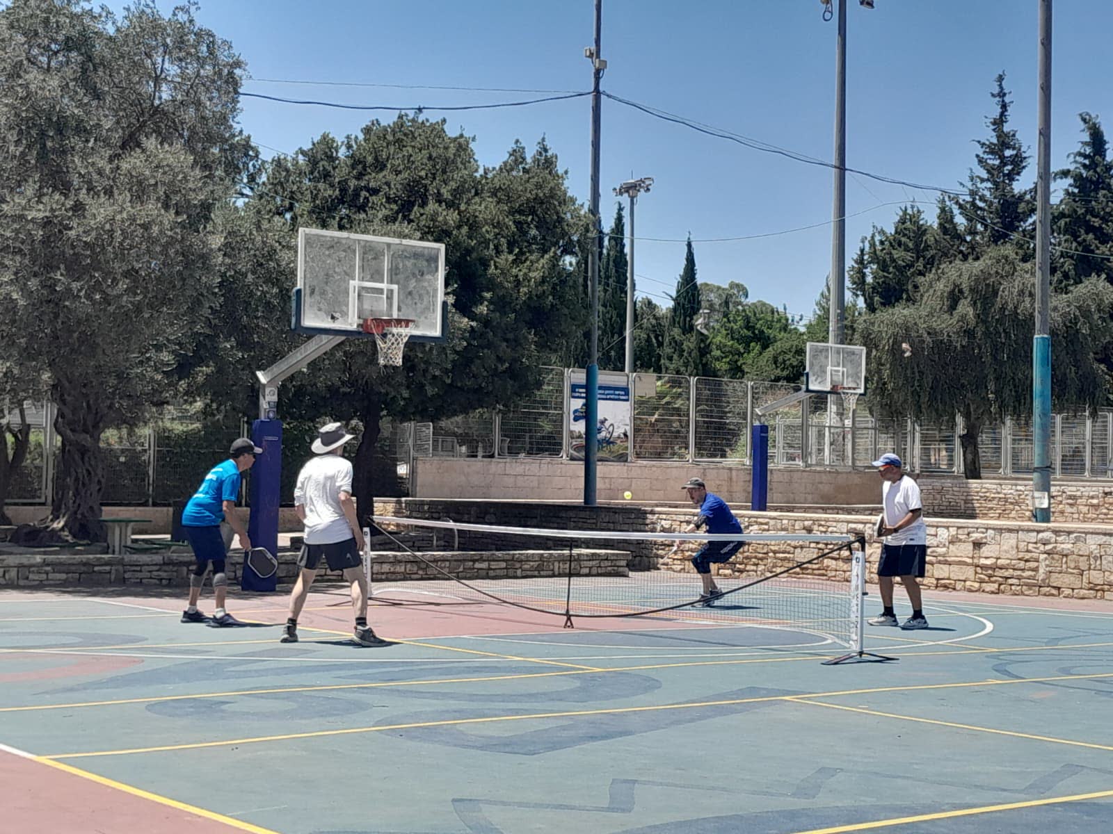 Players rallying on the Gan HaPaamon pickleball court in Jerusalem