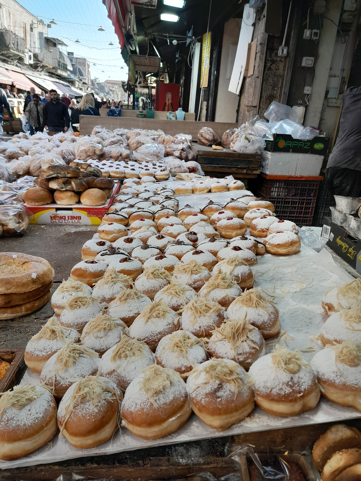 Sufganiyot jelly donuts and rugelach on a bakery table before Hanukkah