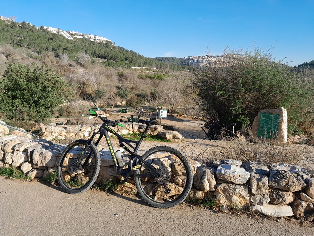 Mountain bike at Ein Lavan spring with Jerusalem hills in the background